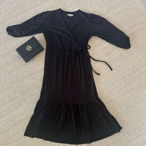Pretty black faux wrap dress with flounced bottom.